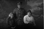 3/4 portrait of Private Harrison and two women. Probably Rifleman George Edward Harrison, Reg No 29398, of the 12th Reinforcements to the 1st Battalion, - E Company. New Zealand Rifle Brigade. 18th Reinforcements (Photographer: Herman Schmidt, 1916). Sir George Grey Special Collections, Auckland Libraries, 31-H2023. No known copyright.