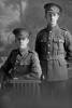3/4 portrait of 2 men of the 3rd (Auckland) Regiment, Auckland Infantry Regiment, one a private and the other is Quartermaster Sergeant Arnold Edgar Mills, Reg No 13/3732, A Company. Killed in action in France on 7 July 1916. (Photographer: Herman Schmidt, 1915|1916). Sir George Grey Special Collections, Auckland Libraries, 31-M811. No known copyright.