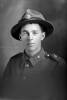 1/4 portrait of Lance Corporal Fairfax Moresby, Reg No 12/4060, of the 6th (Hauraki) Regiment, Auckland Infantry Regiment, - A Company, 10th Reinforcements. (Photographer: Herman Schmidt, 1915|1916). Sir George Grey Special Collections, Auckland Libraries, 31-M843. No known copyright.