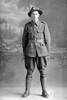 Full length portrait of Lance Corporal Fairfax Moresby, Reg No 12/4060, of the 6th (Hauraki) Regiment, Auckland Infantry Regiment, - A Company, 10th Reinforcements. (Photographer: Herman Schmidt, 1915|1916). Sir George Grey Special Collections, Auckland Libraries, 31-M845. No known copyright.