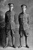 Full length group portrait of Rifleman Edward Montgomery, Reg No 44652, and his brother Rifleman John Montgomery, Reg No 44653, both of the New Zealand Rifles Brigade, J Company, 24th Reinforcements. Edward was killed in action in France on 21st November 1917. (Photographer: Herman Schmidt, 1917). Sir George Grey Special Collections, Auckland Libraries, 31-M3207. No known copyright.