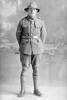 Full length portrait of Lance Corporal J M McNichol, possibly (Corporal in the roll) John Malcolm McNicol, Reg No 17/400, of the New Zealand Veterinary Corps. (Photographer: Herman Schmidt, 1916). Sir George Grey Special Collections, Auckland Libraries, 31-N886. No known copyright.