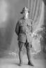 Full length portrait of Private Charles Patrick O'Hanlon, Reg No 66008, of the Otago Infantry Regiment, - D Company, 33rd Reinforcements. (Photographer: Herman Schmidt, 1917). Sir George Grey Special Collections, Auckland Libraries, 31-O3868. No known copyright.