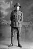 Full length portrait of Private Pirritt (?) of the New Zealand Medical Corps, possibly William Deans Pirrett, Reg No 3/2690, or John Cameron Pirrit, Reg No 3/1789. (Photographer: Herman Schmidt, 1916). Sir George Grey Special Collections, Auckland Libraries, 31-P916. No known copyright.
