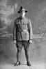 Full length portrait of Private (Lance Corporal in the roll) Frank Pugh, Reg No 40459, of the Specialist Company (Signal Section), wearing a qualified signaller proficience badge. (Photographer: Herman Schmidt, 1917). Sir George Grey Special Collections, Auckland Libraries, 31-P2437. No known copyright.