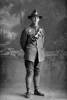 Full length portrait of Gunner Richard Beaumont Penny, Reg No 43870, of the New Zealand Field Artillery. (Photographer: Herman Schmidt, 1917). Sir George Grey Special Collections, Auckland Libraries, 31-P3456. No known copyright.
