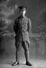 Full length portrait of Lance Corporal John Wenzyl Schollum, Reg No 3/2503, of the New Zealand Medical Corps. (Photographer: Herman Schmidt, 1916). Sir George Grey Special Collections, Auckland Libraries, 31-S2149. No known copyright.