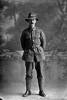Full length portrait of Private F Smith of the 24th Reinforcements, probably Frederick John Smith, Reg No 42418, Auckland Infantry Regiment, - A Company. (Photographer: Herman Schmidt, 1917). Sir George Grey Special Collections, Auckland Libraries, 31-S3262. No known copyright.