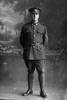 Full length portrait of Corporal (Sergeant in the nominal roll) Charles William Twiname, Reg No 14507, of the Auckland Infantry Battalion, - A Company, 14th Reinforcements. (Photographer: Herman Schmidt, 1916). Sir George Grey Special Collections, Auckland Libraries, 31-T1248. No known copyright.
