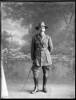 Full length portrait of Colonel James Neil McCarroll, with a moustache, wearing the uniform of the 11th North Auckland Mounted Rifles, campaign medals (Photographer: Herman Schmidt, ). Sir George Grey Special Collections, Auckland Libraries, 31-WP879A. No known copyright.