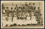 Unknown photographer (1917) No2 N.Z.G. Hosp Walton-on-Thames. Oct 8. 1917.  A group portrait in four rows. There are 7 nurses in uniform sitting on the from row with three rows/24 patients around them. One man in the back row has an "X" over his head indicating he is the sender of the card. Many of the patients have slings or other bandages. Auckland War Memorial Museum call no. D570 M48 W241 p9. Image has no known copyright restrictions.