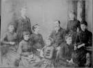 Group portrait of Russell family showing Edward Russell, Nina Russell (standing), Agnes Russell, Mary Ann Russell, John Benjamin Russell, Emily Russell (seated, middle row), Winifred Russell, Grace Russell and Ada Russell (front row). Sir George Grey Special Collections, Auckland Libraries, 7-A14661. Image has no known copyright restrictions.