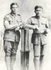 Portrait of Private Mologa Ah Mu (16/1405), 4th Maori Contingent and Private James Swanney (16/1419), 4th Maori Contingent. Portrait taken in Auckland sometime between attestation on 03 February 1916 and departure on 05 May 1916 for the SS Mokoia / HMNZT 52 in Wellington. Photographer: Percival Kingsford Daws (1872-1939), The Crown Studios, 266 Queen Street, Auckland. Image kindly provided from the Christina Heath collection. Image has no known copyright restrictions.