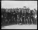 Scales, Thomas Frederick Scales [1918-1919].     Group portrait of World War I New Zealand Services rugby players standing at a match in France. The captain has the rugby ball between his feet. A civilian holds a French tricolour flag. Arthur Percy Singe (fifth from the right). Royal New Zealand Returned and Services' Association Collection, Alexander Turnbull Library, Wellington, New Zealand (1/2-014260-G). Image has no known copyright restrictions.