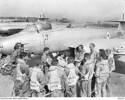 Photograph of 77 Squadron pilots being briefed by Commanding Officer Squadron Leader Richard Cresswell on the Kimpo airfield tarmac prior to a mission over North Korea. Flight Lieutenant Max Scannell is standing second from left. Australian War Memorial, JK0025. Image has no known copyright restriction.