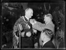 Captain Parry of HMS Achilles. Showing Captain Parry of HMS Achilles being presented with a Maori cloak at a reception at the Auckland Town Hall. February 1940. Auckland Libraries Heritage Collections 1370-289-6. Copyright or other restrictions may apply to this image.