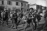 Kaye, George Frederick, 1914-2004. Soldiers of the Maori Battalion moving into line in the Faenza sector, Italy, during World War II. New Zealand. Department of Internal Affairs. War History Branch :Photographs relating to World War 1914-1918, World War 1939-1945, occupation of Japan, Korean War, and Malayan Emergency. Soldiers of the Maori Battalion moving into line in the Faenza sector, Italy, during World War II. Includes Jack Love (foreground, right), Hapurona Rangi (walking behind Love), and Ned Nathan (beside Love, on his left). Photograph taken by George Kaye on 16 December 1944. Alternative identification of soldiers from the 28 Maori Battalion website (www.28maoribattalion.org.nz), left to right; Monte Robson (39454), Joseph Tai Angell (39288), Colin Fisher (39317), Leslie Pirihi (39688), Edward Nathan (2880) and Joe Hoterene (39332). Many of the men identified either died in Crete in 1941 or were POWs in 1941. Which suggests that either the photo was actually taken at another date/place. Other - Note on back of file print from Library client reads "Ned Nathan - centre front row - was wounded in Crete, so possibly, this is is not Italy, but Crete..." Ref: DA-07880. Alexander Turnbull Library, Wellington, New Zealand. /records/23243221
