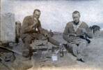 Photograph of 'Wynton French (left) and a friend enjoy Christmas dinner at Rafa, December 25, 1918.' Image courtesy of Wairarapa100. Image may be subject to copyright restrictions.