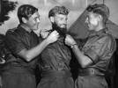 Photograph of Pilot Officers Bruce Thompson (left) and Vance Drummond (right) admiring the beard of Flight Lieutenant John Hannan, Royal Australian Air Force, c.1953. Associated Press, State Library of Victoria, H98.103/3743. Image has no known copyright restrictions.