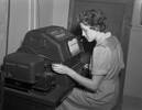 Joan Rowberry, a member of the Women's Auxiliary Air Force using a teletype machine. Suva, Fiji. Air Force Museum of New Zealand PR1876.