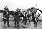 Photograph of 485 Squadron pilots, walking away from a Spitfire, RAF Station Driffield, 1941. From left to right: James Kerrow Porteous, A.G. McIntyre, Kevin Desmond Cox, William Arthur Middleton, A.B. Smith, and Jack Maney. Names sourced from the book 'An Illustrated History of the New Zealand Spitfire Squadron' by Kevin W Wells. Air Force Museum of New Zealand, HIST533. Image is subject to copyright restrictions.