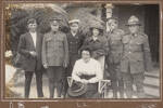 A woman with five men and a young woman. Three of the men wear army uniforms and one a navy uniform: Donovan Graham Lunn (second from the left) Lionel Victor Lunn (second from right) and Vera Lunn (centre) wearing a great coat. The Lunn family lived at 5 Tui Street, Devonport. Gorphwysfa, Devonport, is listed on Lionel's enlistment forms. Auckland Libraries Heritage Collections 499-ALB116F-54-01. No known copyright restrictions.
