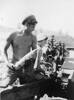 'Gunner G Horsefall standing by to reload a 25 pounder, Korea', October 1951, Alexander Turnbull Library, Wellington,    PA1-q-311-0415.