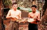 Pte Brian Hills & Dave Naera of 10 Pl with the pick of the catch (a SEBARAU) a freshwater species of Malaysia. Image taken during Malayan Emergency 1959-1960. © Peter Gallacher.