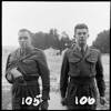 Photograph of (from left) Trooper M W Flavell (from Matiere) and Corporal David Lance Ogilvy (from Auckland), members of the New Zealand Army Special Air Service. Photograph taken by an unidentified New Zealand Army photographer circa 1955, during the Malayan Emergency (1948-1960). Alexander Turnbull Library, Wellington, SAS-105/SAS-106-F
