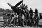 Group of No. 486 Squadron personnel with one of their Hurricanes. RAF Station Wittering. Standing; VC Fittall, LV Weir, KG Taylor-Cannon, AE Umbers, CLC Roberts (Commanding Officer), HN Sweetman, GE Rawson, NE Preston, RH Fitzgibbon, BC Thompson, AJ Woodgate. Front; T Ness (Adjutant), HC Saward, GG Thomas, CN Gall, F Murphy, ID Waddy, L Walker, RI Phillips, RJ Dall. Image kindly provided by the Air Force Museum of New Zealand from the Rodney Fairbrother personal collection. 1988-1176.13